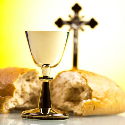 Keltaisella taustalla risti, ehtoollismalja ja leipää.