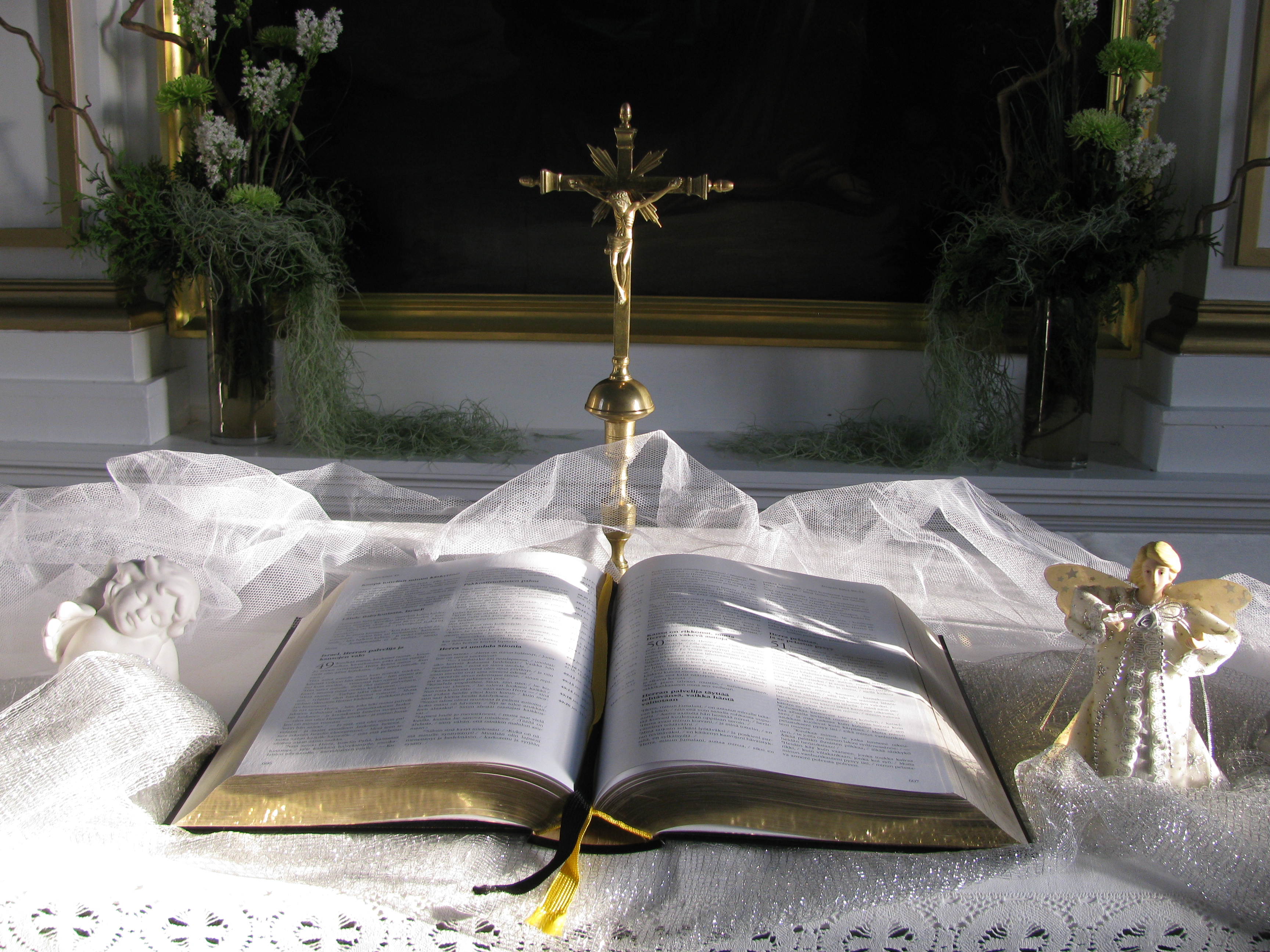 Raamattu, risti ja kaksi enkeliä Hämeenkyrön kirkon alttarilla.